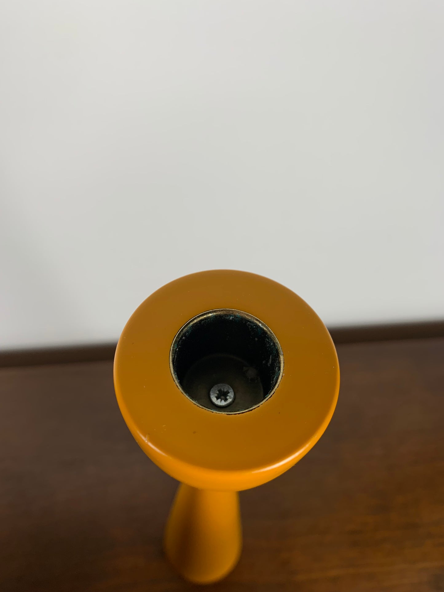 Large candle holder in orange-yellow lacquered wood
