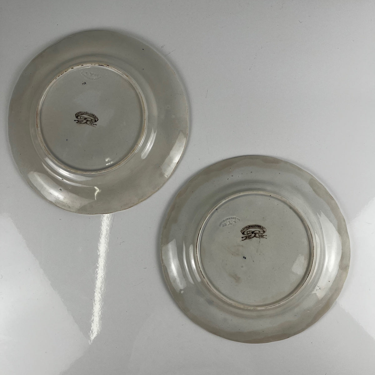 Pair of antique fine earthenware dessert plates by David Johnston (Bordeaux), 19th century.