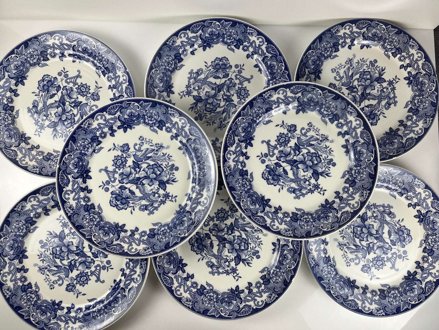 Set of 8 blue earthenware dinner plates with floral and bird decoration, early 20th century