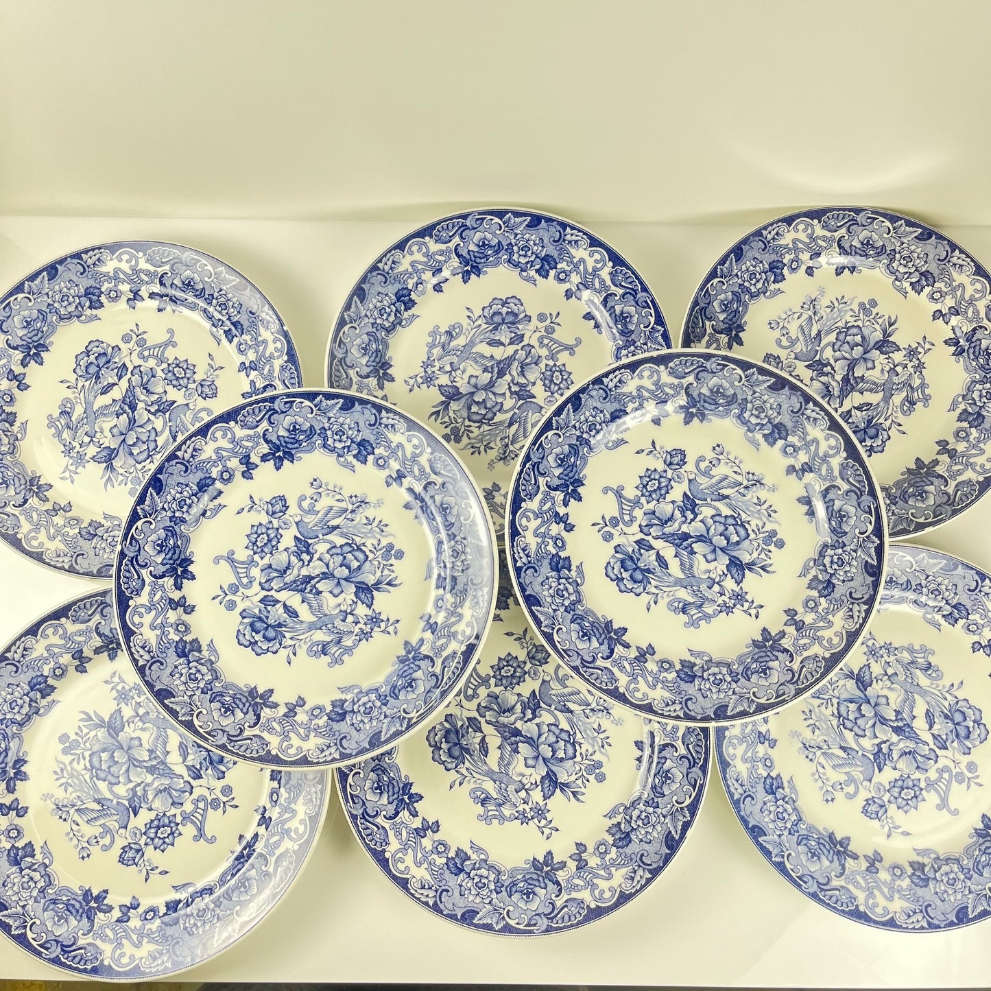 Set of 8 blue earthenware dinner plates with floral and bird decoration, early 20th century