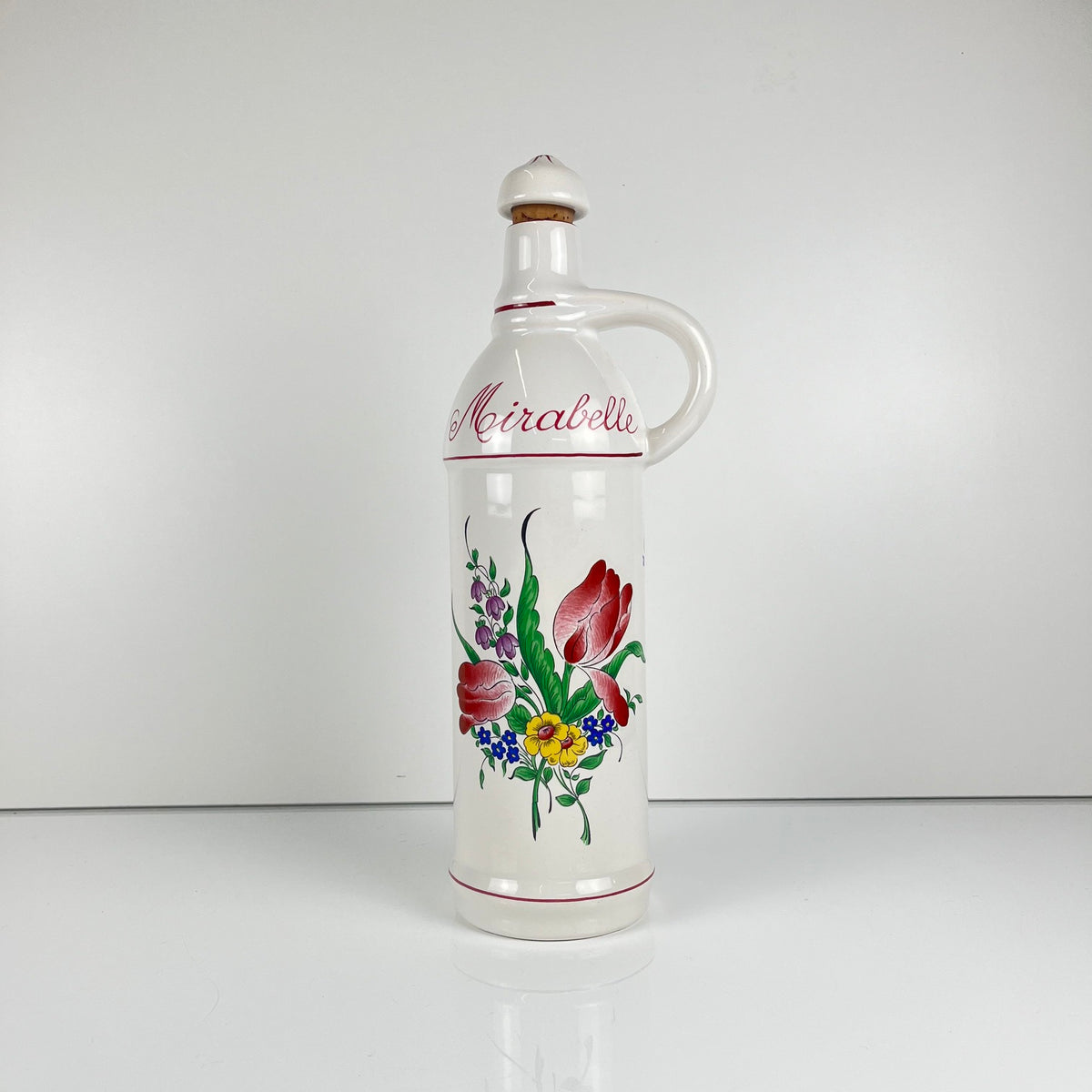 "Mirabelle" bottle, "Réverbère" model by KG Lunéville, tulip and rose pattern.