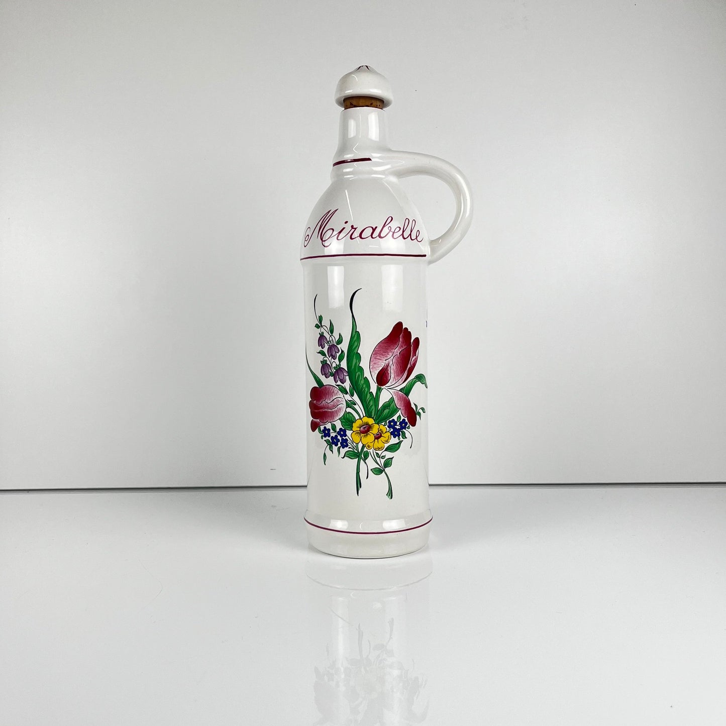 "Mirabelle" bottle, "Réverbère" model by KG Lunéville, tulip and rose pattern.