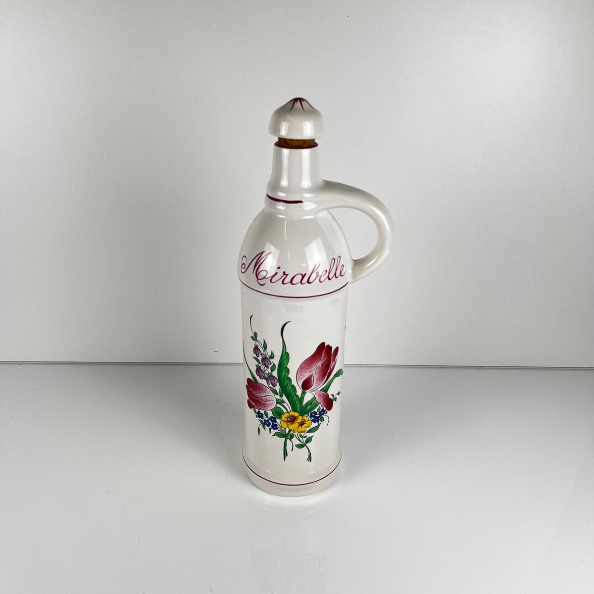 "Mirabelle" bottle, "Réverbère" model by KG Lunéville, tulip and rose pattern.