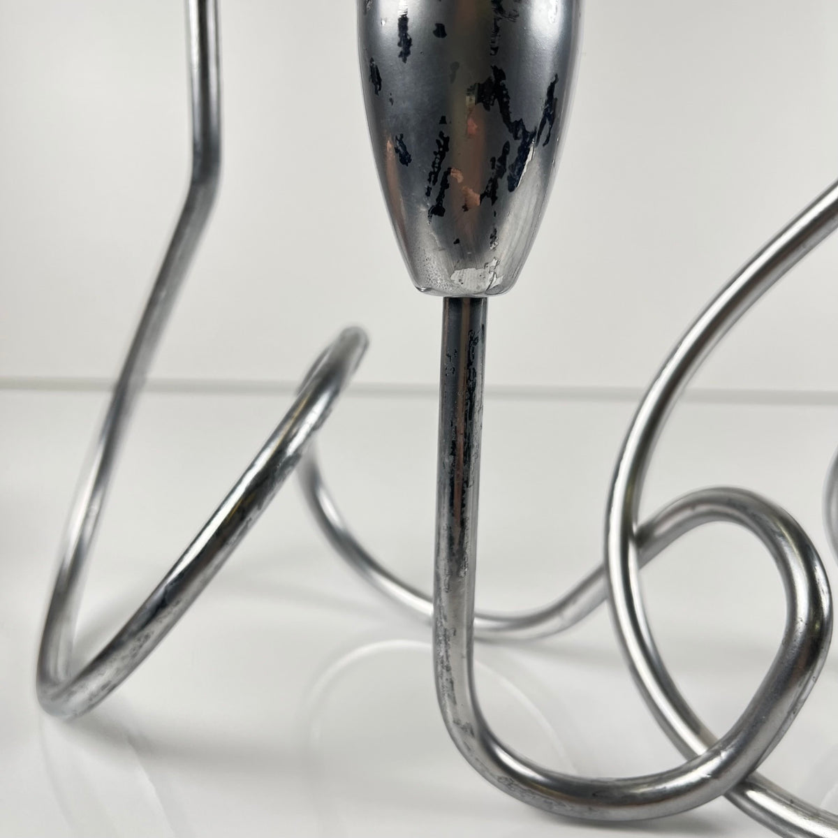 “Loop” style candle holder, 2000, chrome-plated metal