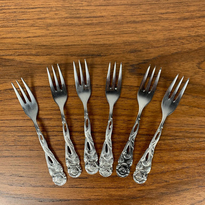 Antique silver metal dessert spoons and forks, flower motif