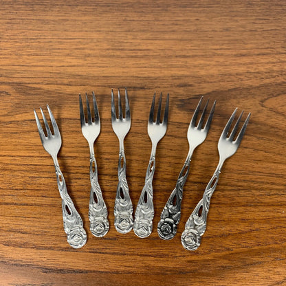 Antique silver metal dessert spoons and forks, flower motif