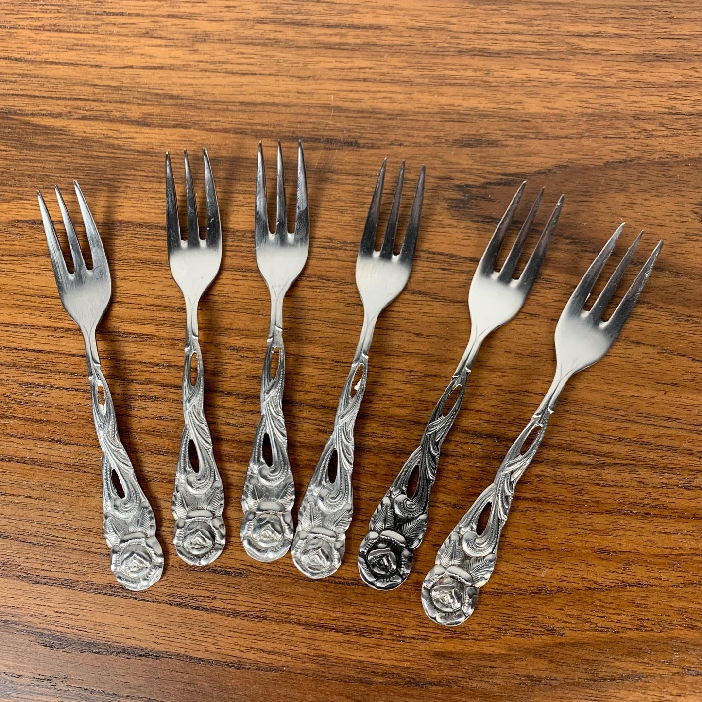 Antique silver metal dessert spoons and forks, flower motif