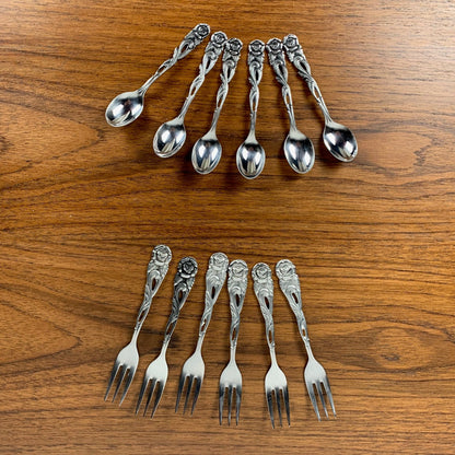 Antique silver metal dessert spoons and forks, flower motif