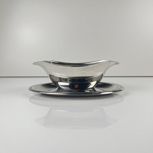 Silver-colored Empire-style metal gravy boat