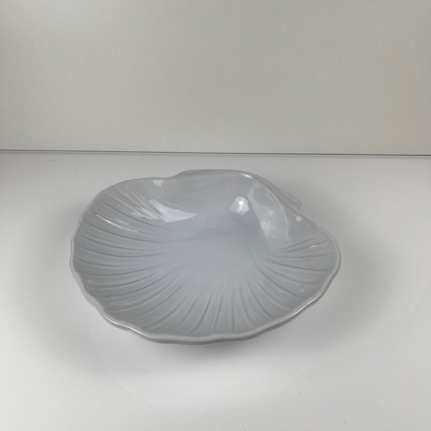 Large platter in the shape of a scallop shell, Emile Henry, France, mid-20th century