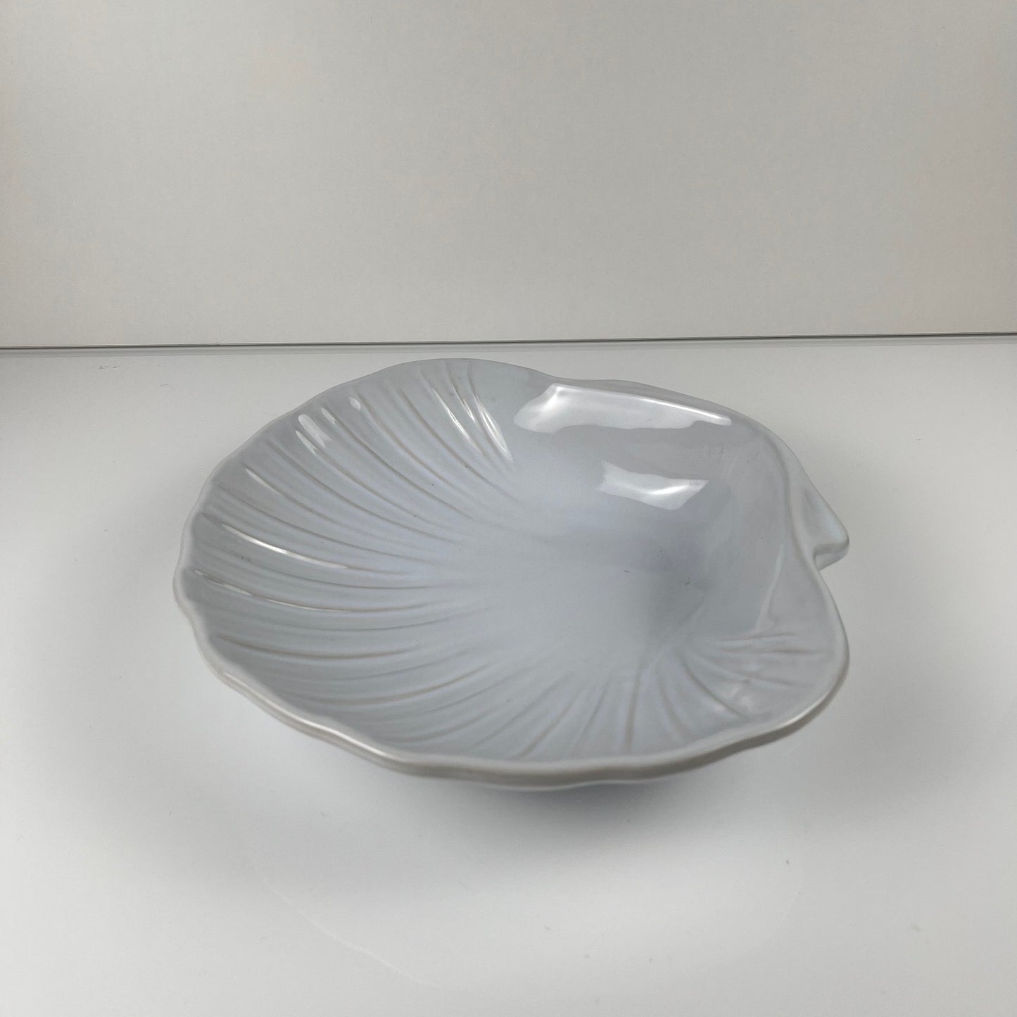Large platter in the shape of a scallop shell, Emile Henry, France, mid-20th century