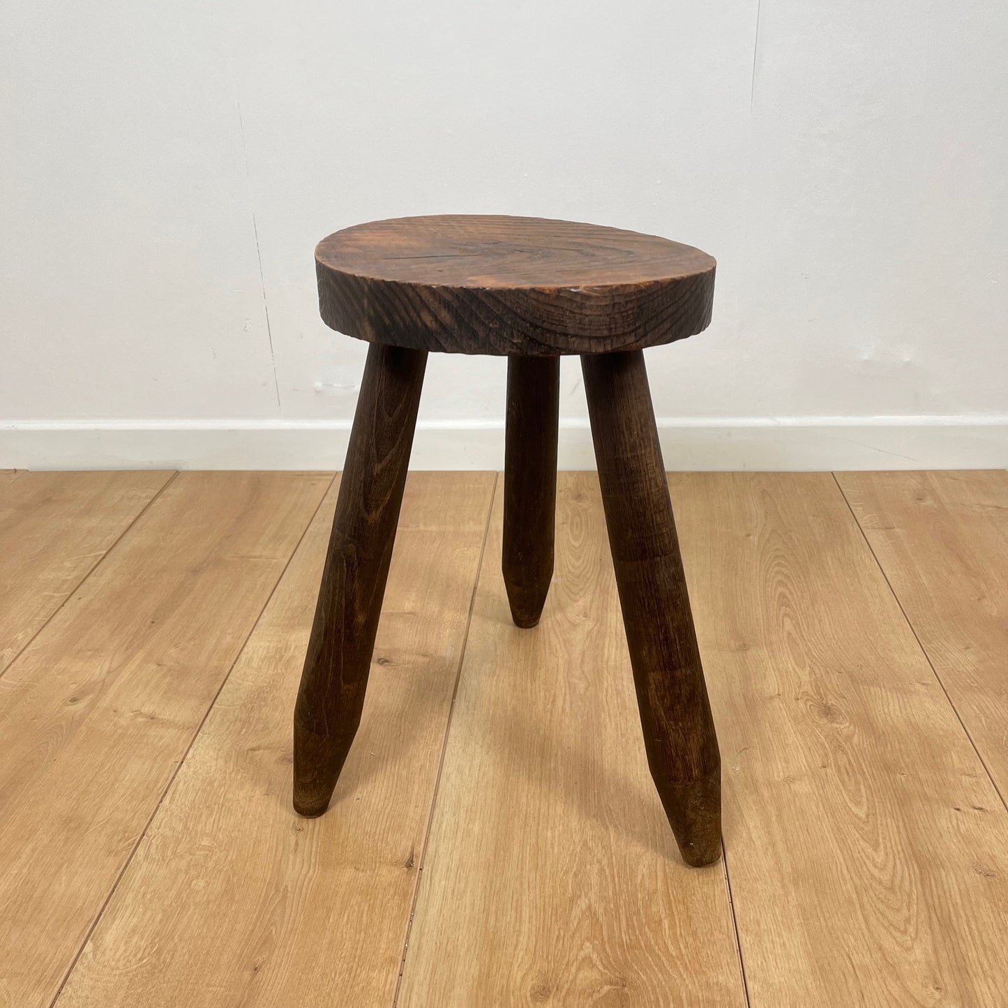 Petit tabouret tripode brutaliste en bois massif