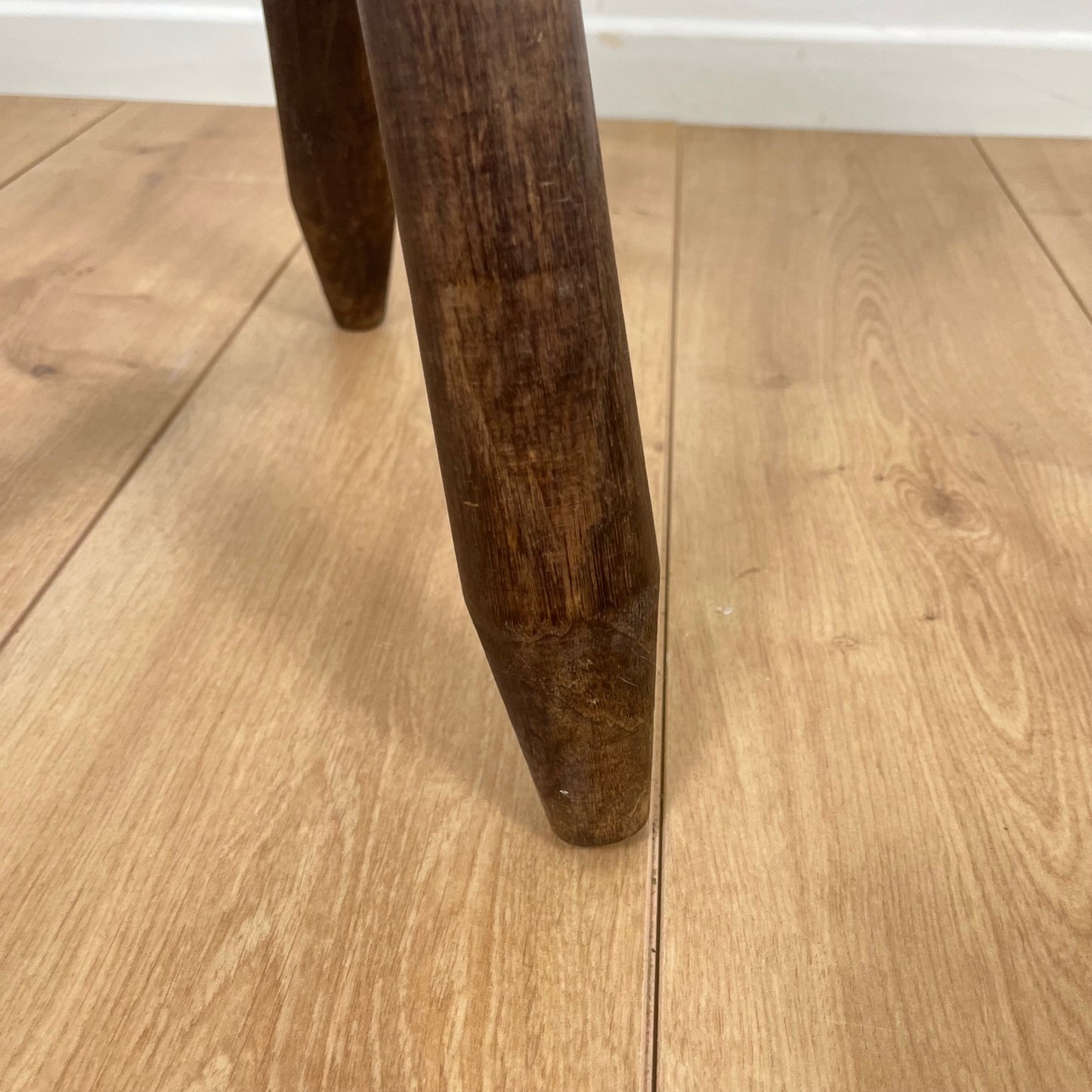 Petit tabouret tripode brutaliste en bois massif