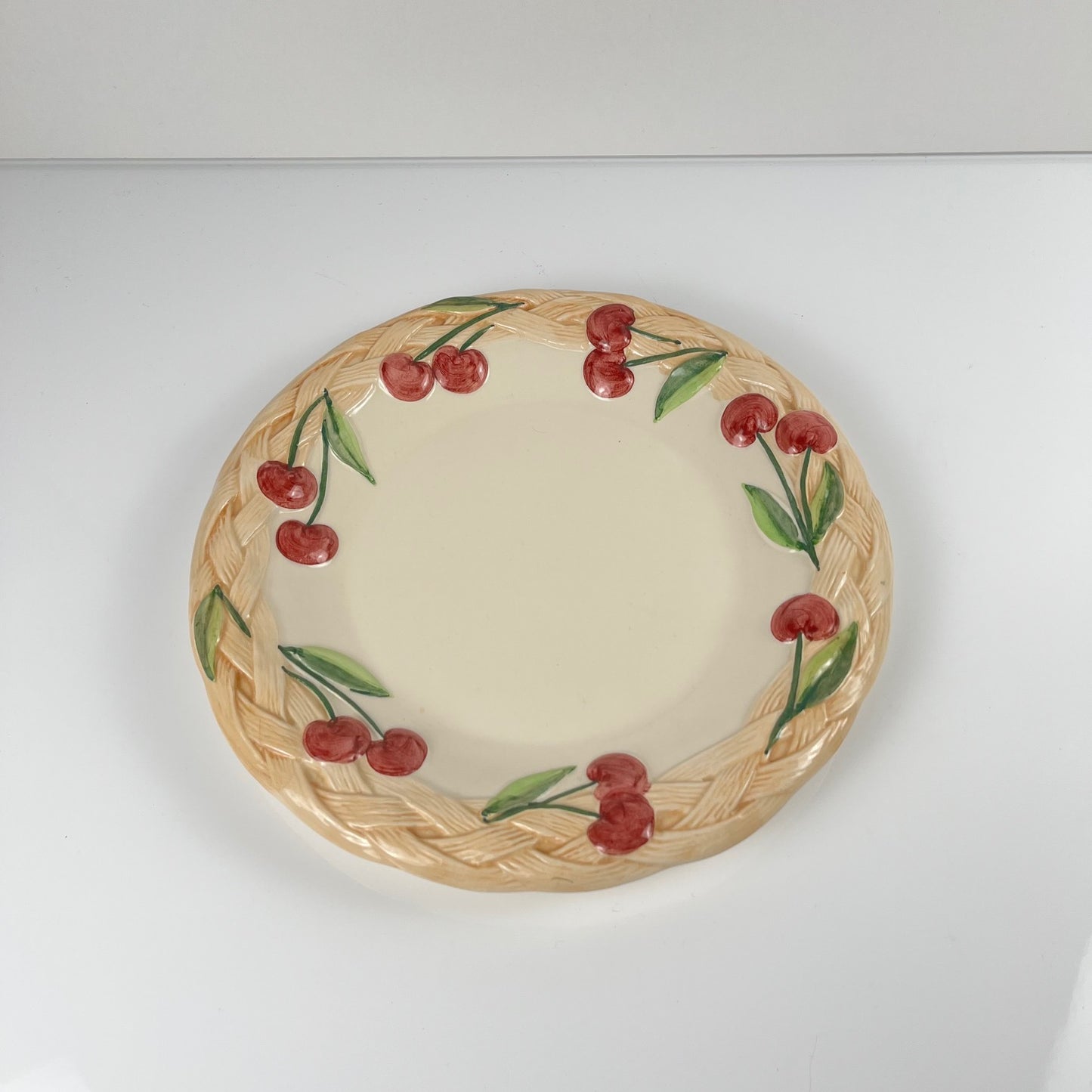 Antique earthenware dish with cherry pattern, signed "FG", 20th century