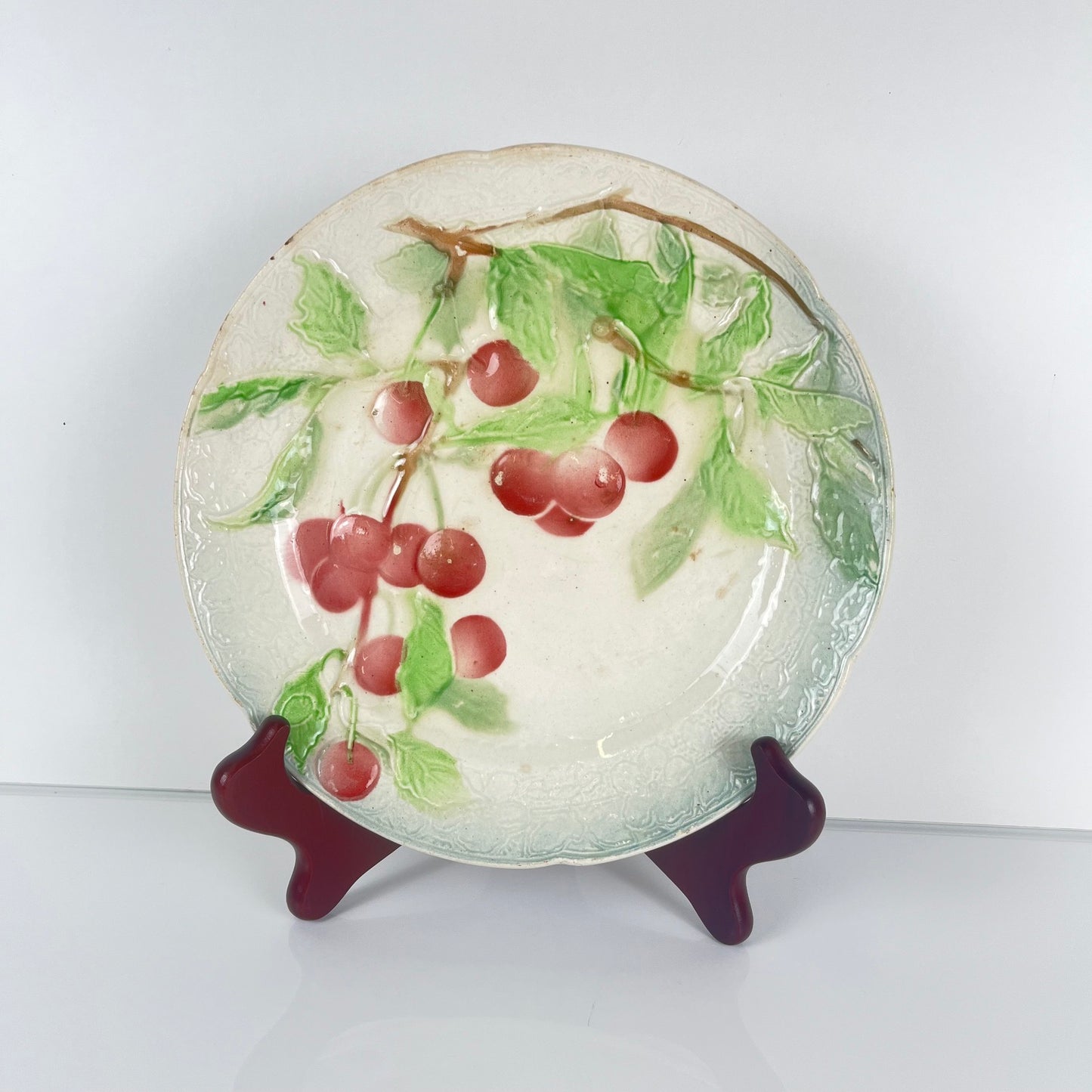 Set of 4 KG St Clément barbotine fruit plates (cherry, mirabelle plum, grape, pear), late 19th-early 20th century