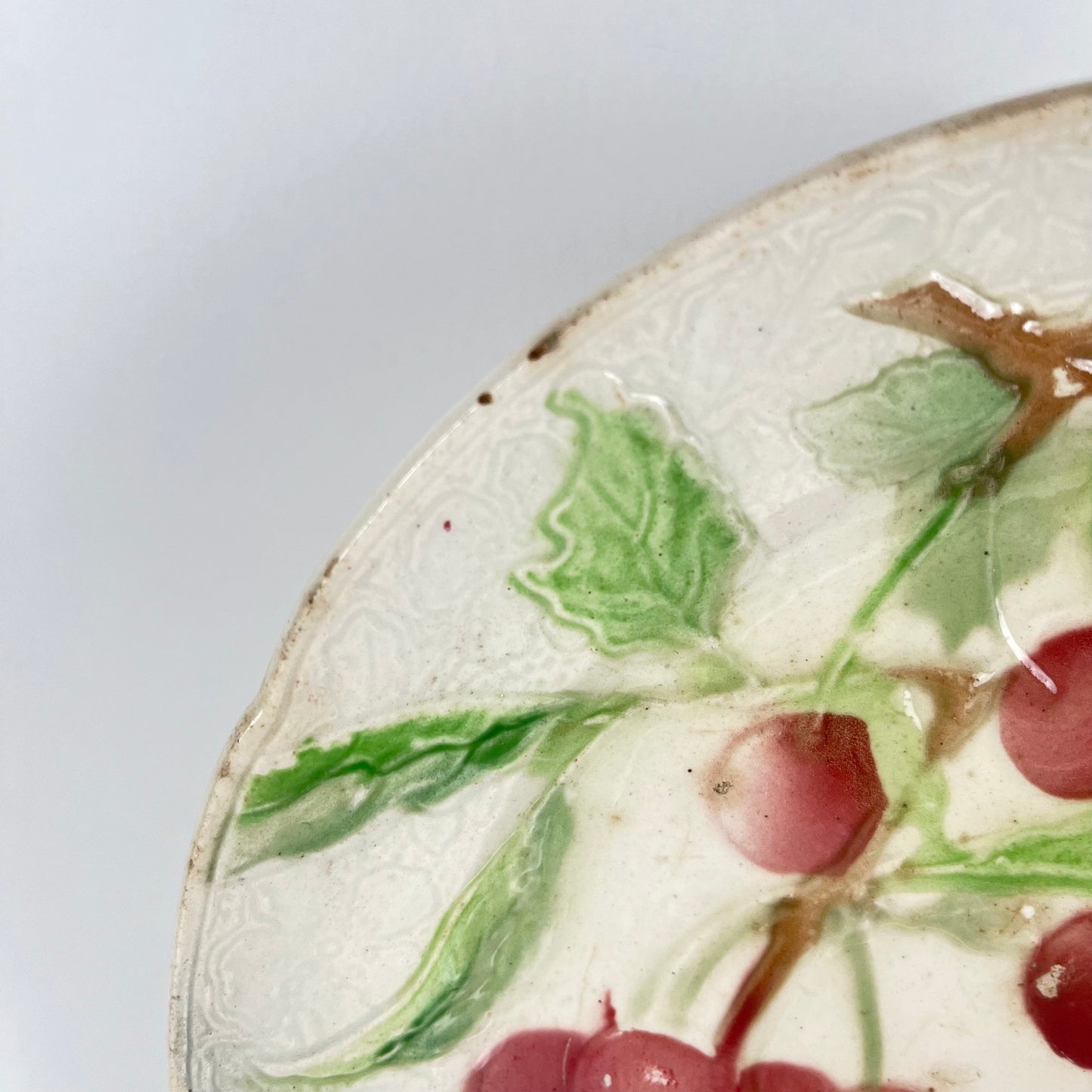 Set of 4 KG St Clément barbotine fruit plates (cherry, mirabelle plum, grape, pear), late 19th-early 20th century