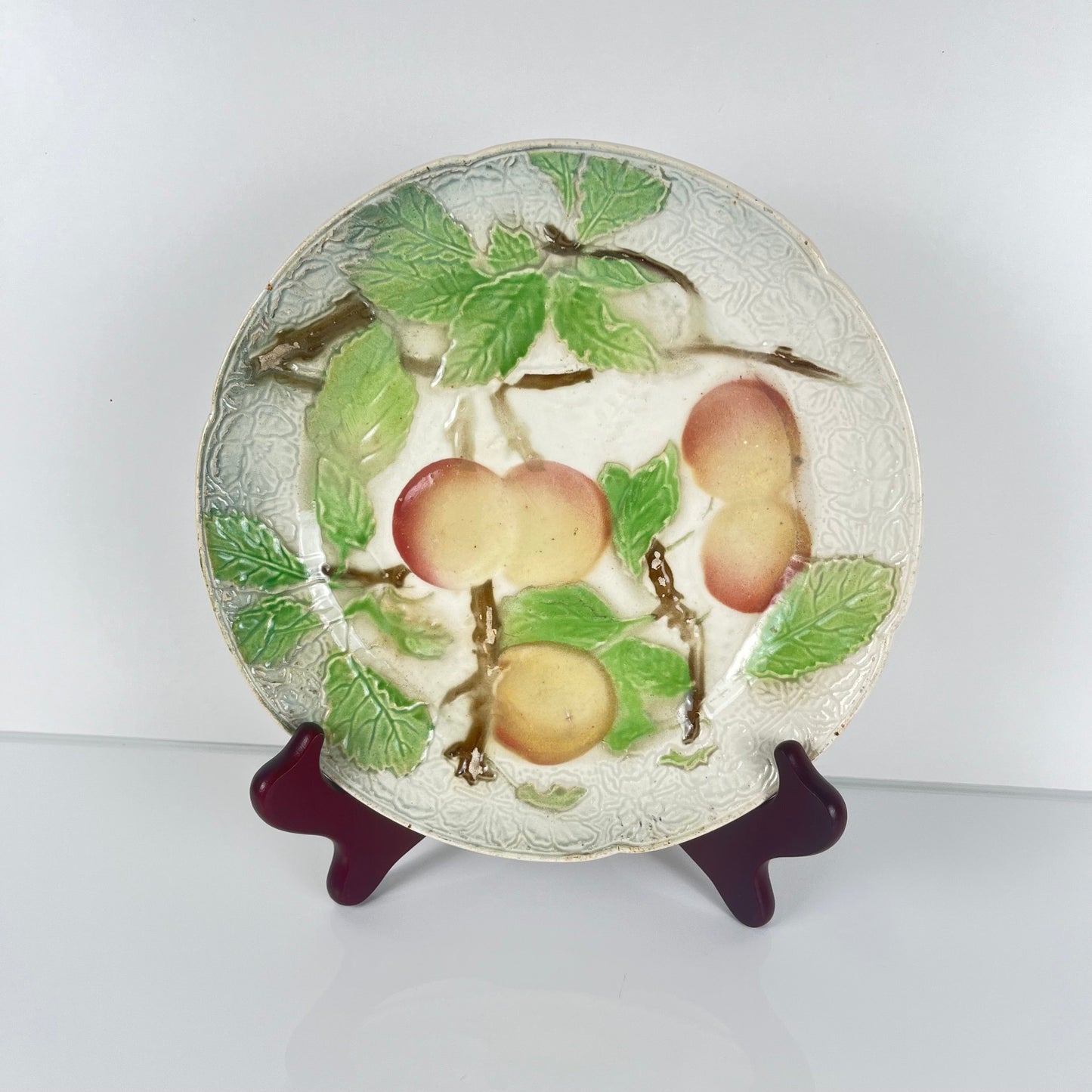 Set of 4 KG St Clément barbotine fruit plates (cherry, mirabelle plum, grape, pear), late 19th-early 20th century