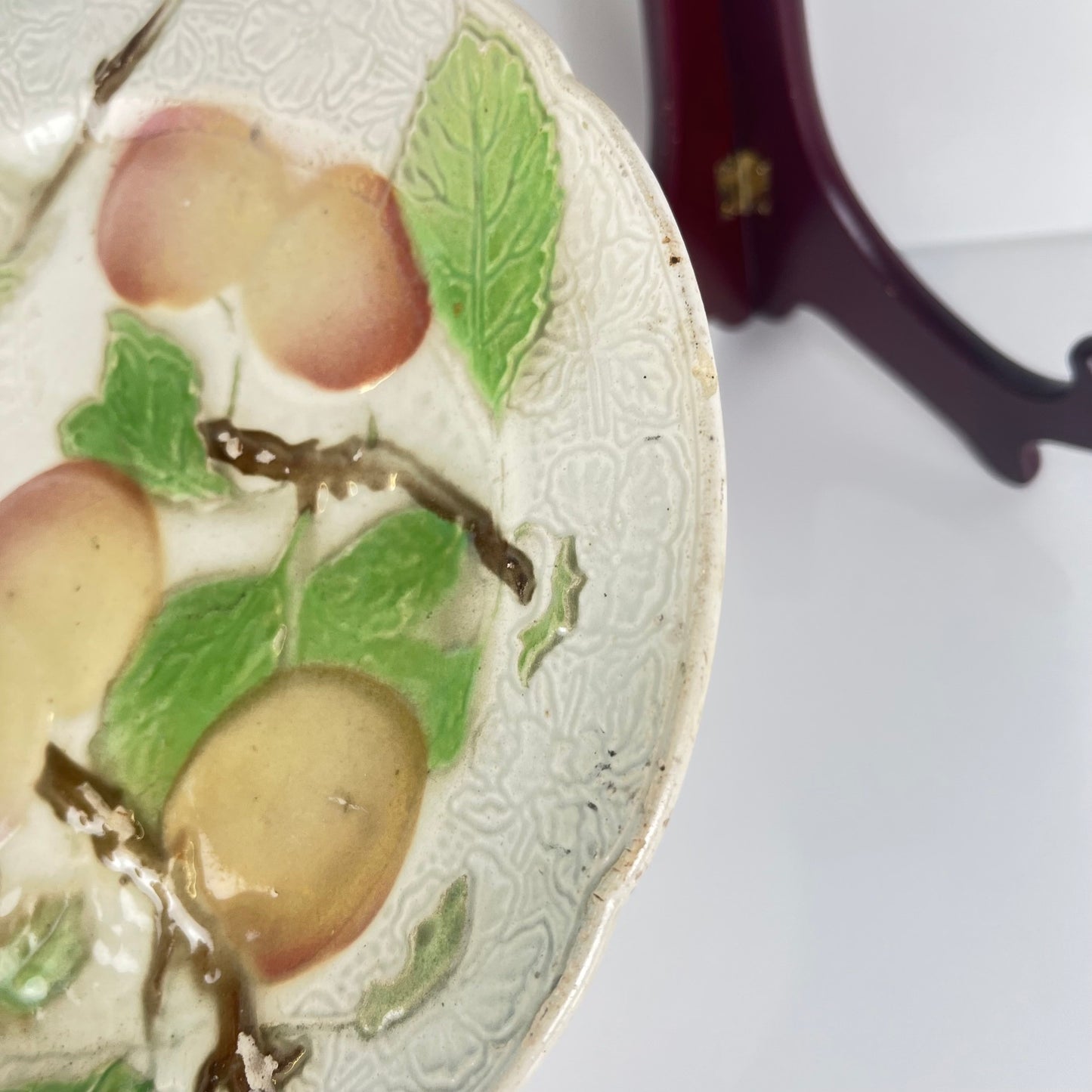 Set of 4 KG St Clément barbotine fruit plates (cherry, mirabelle plum, grape, pear), late 19th-early 20th century