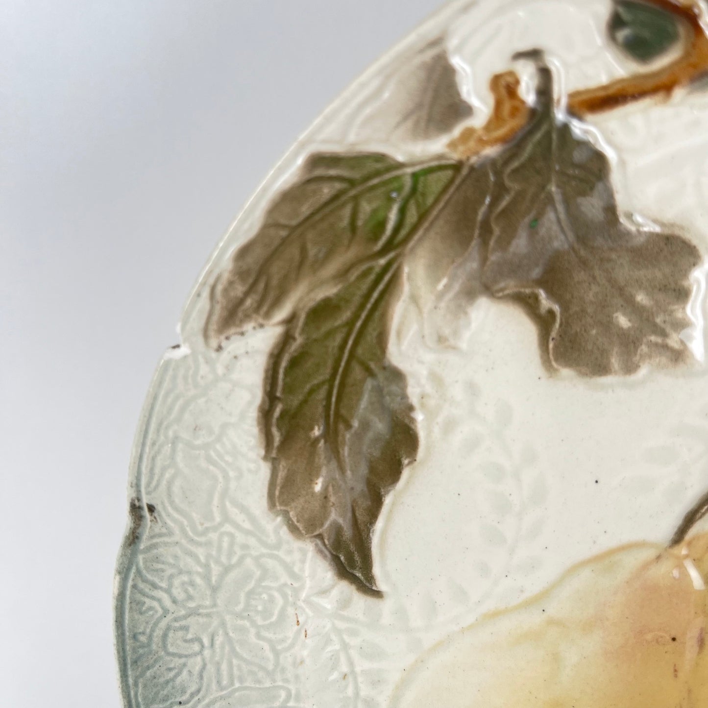 Set of 4 KG St Clément barbotine fruit plates (cherry, mirabelle plum, grape, pear), late 19th-early 20th century