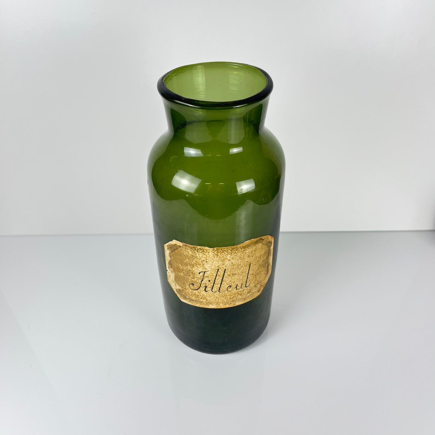 Large antique apothecary bottle in green blown glass