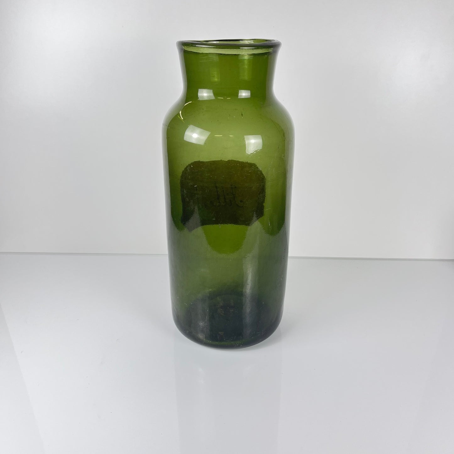 Large antique apothecary bottle in green blown glass
