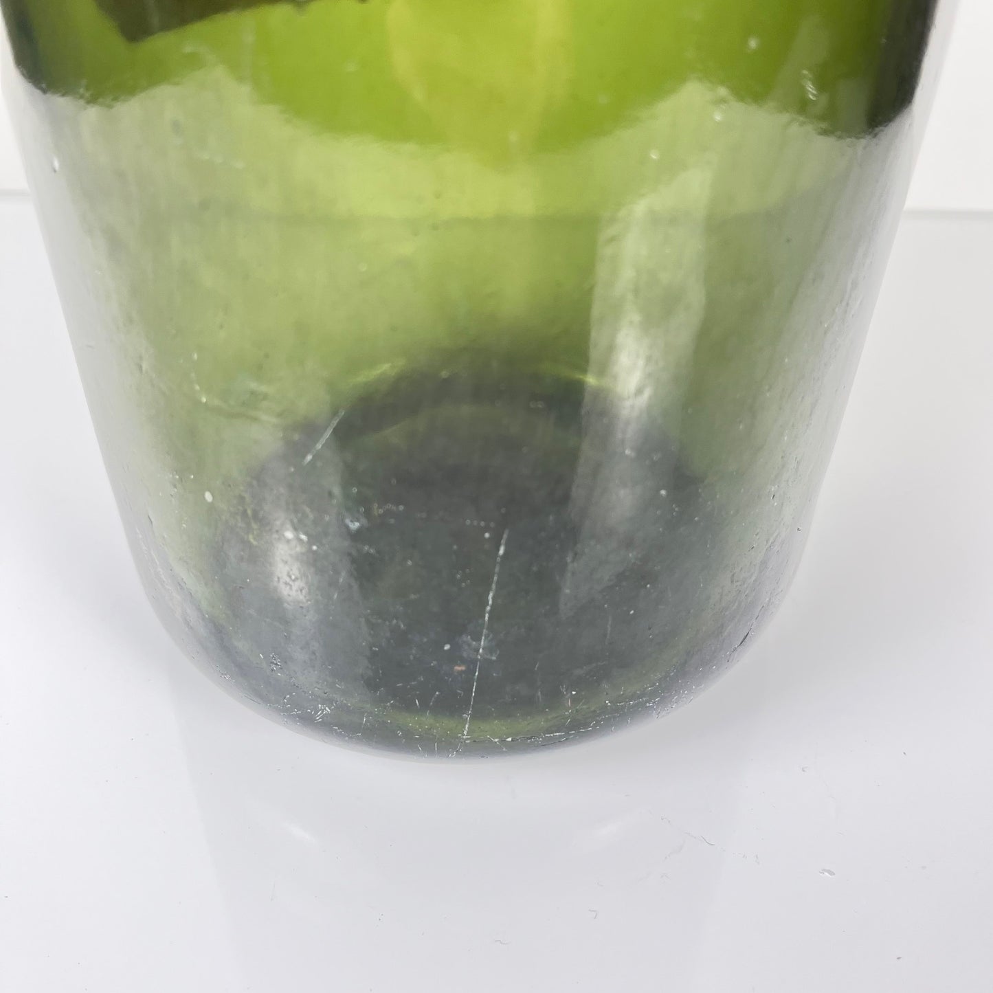 Large antique apothecary bottle in green blown glass