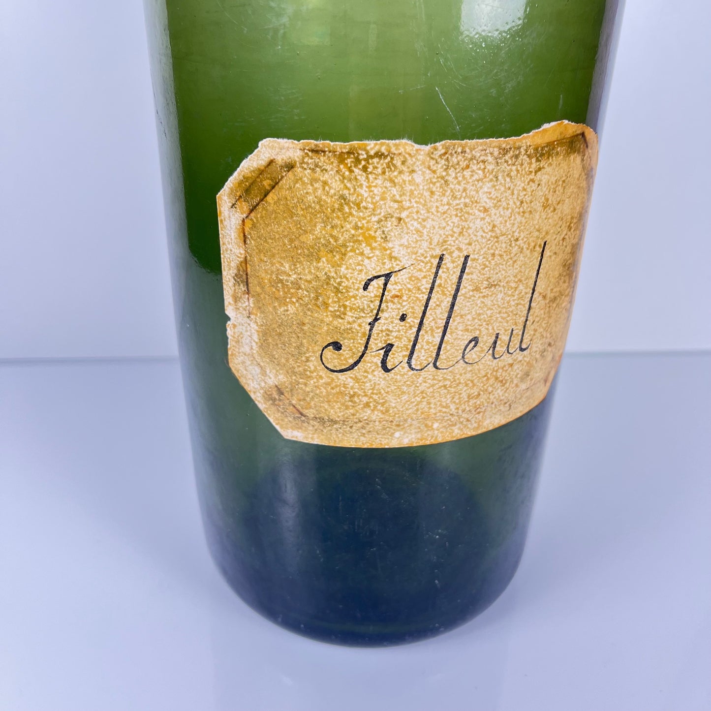 Large antique apothecary bottle in green blown glass