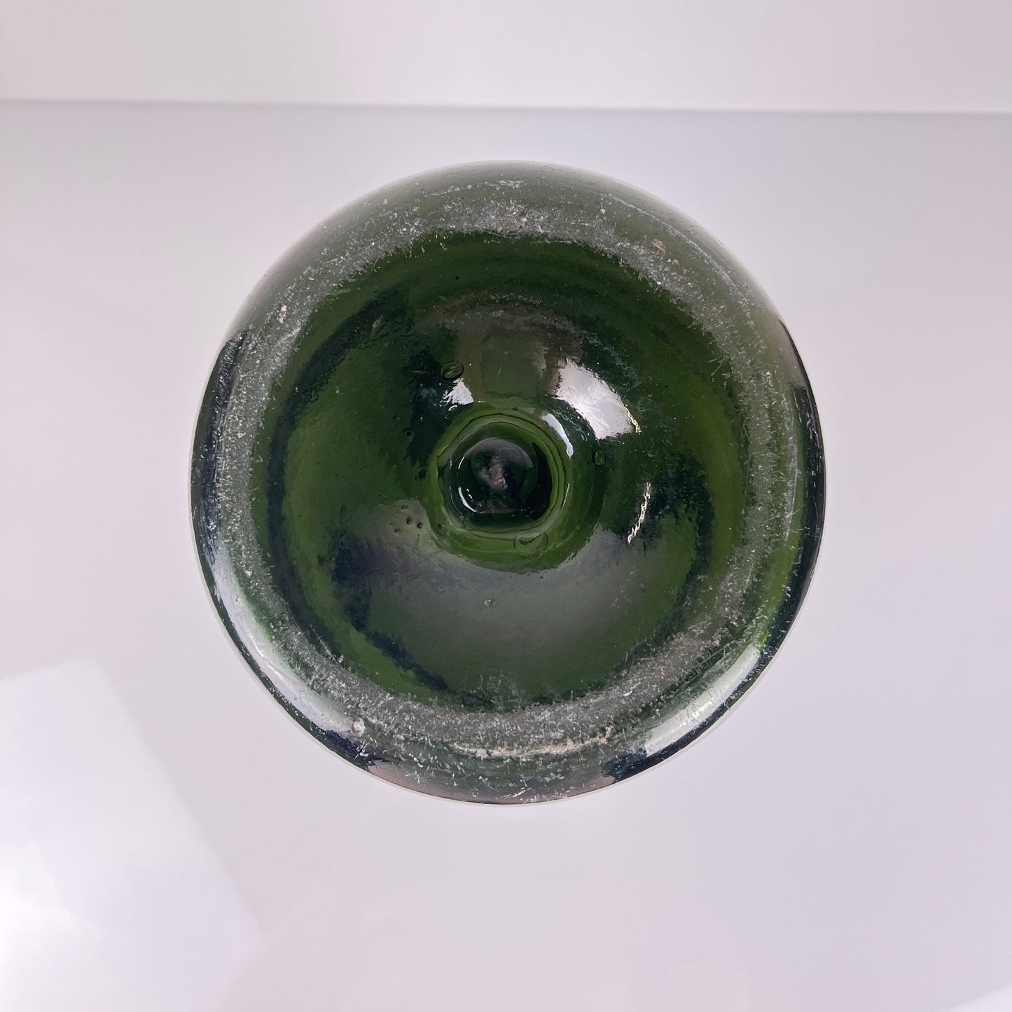 Large antique apothecary bottle in green blown glass