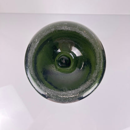 Large antique apothecary bottle in green blown glass