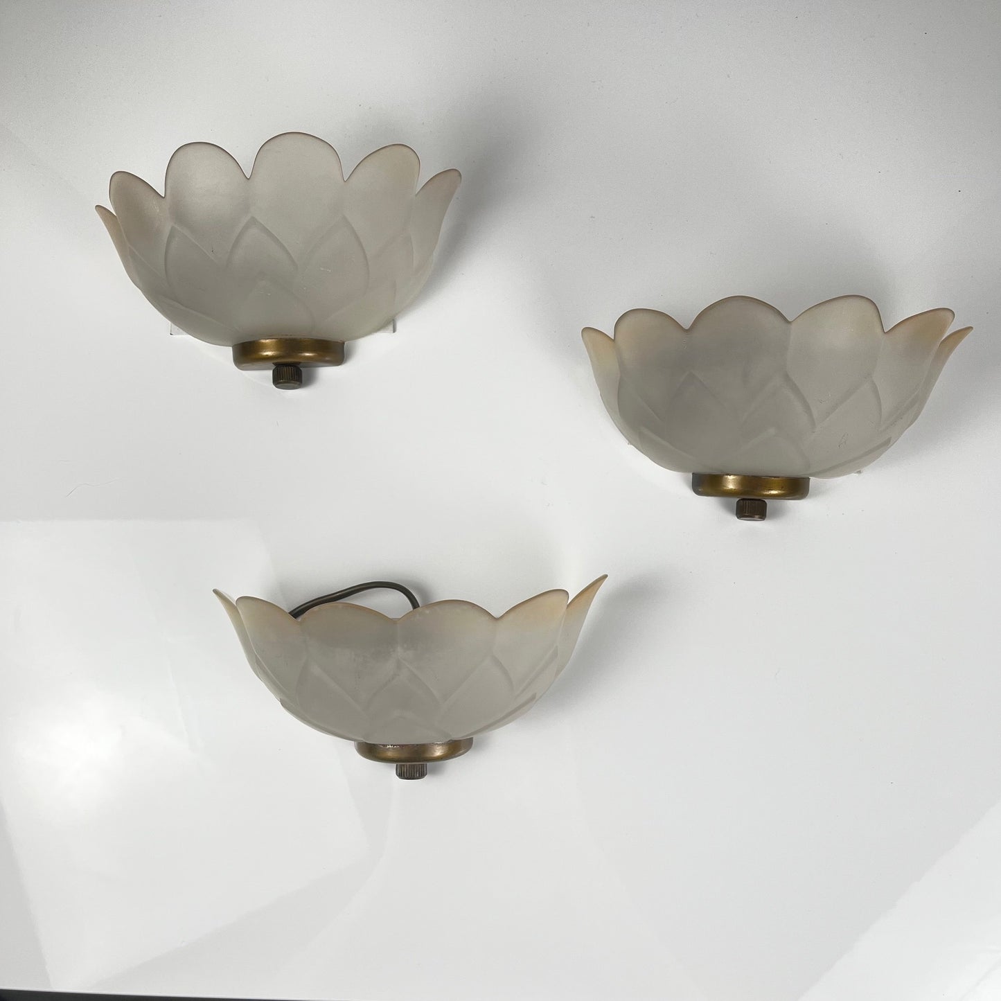 Trio of vintage frosted glass and brass wall sconces