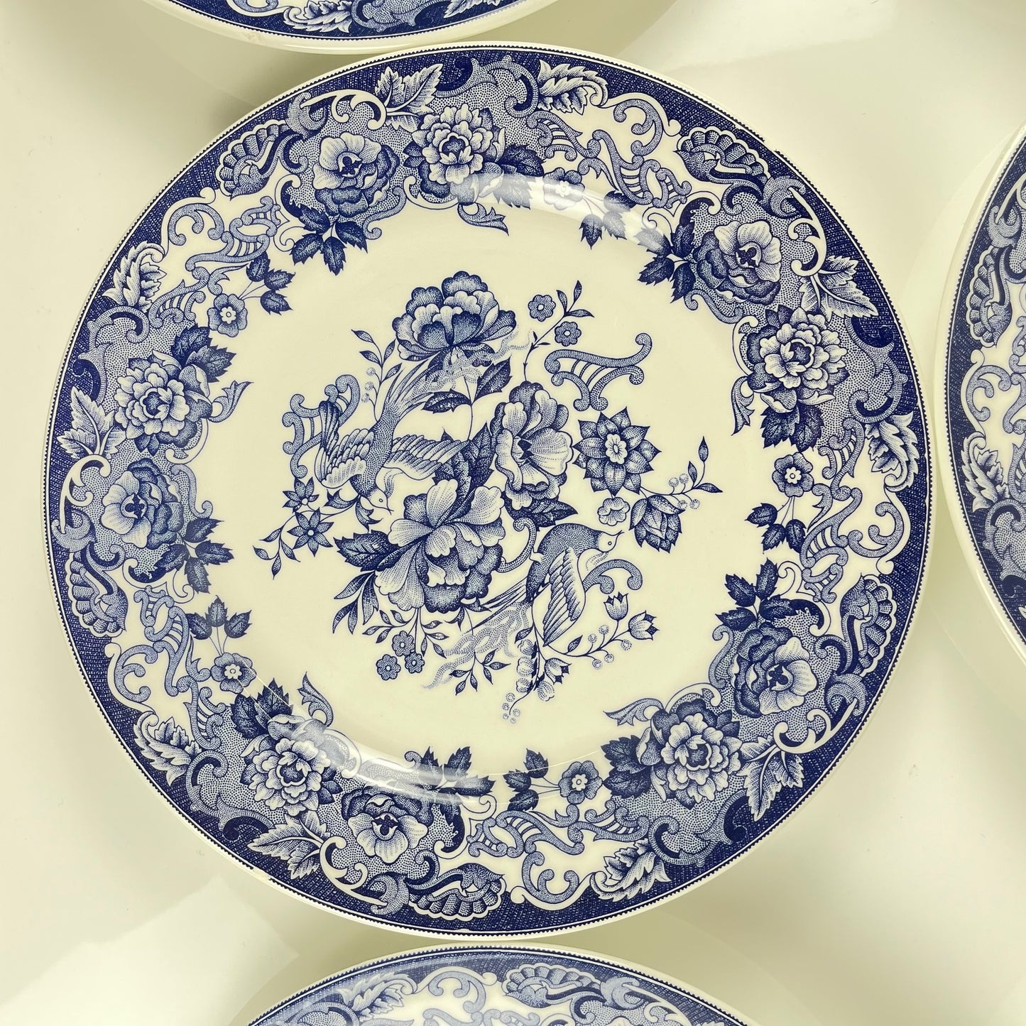 Set of 8 blue earthenware dinner plates with floral and bird decoration, early 20th century