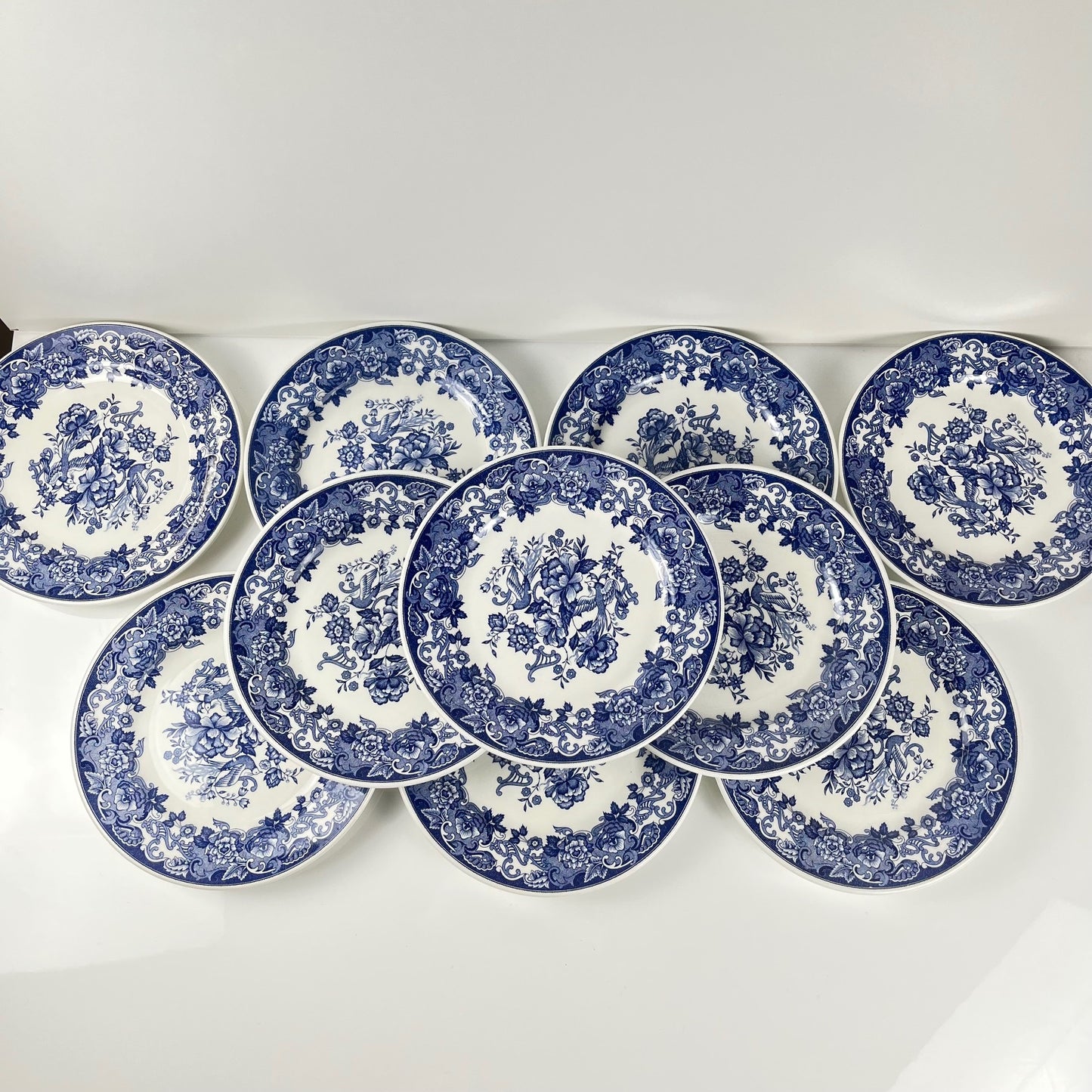 Set of 10 blue earthenware dessert plates with floral and bird decoration, early 20th century